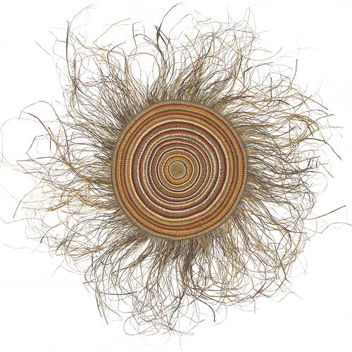 a woven rug with brown and yellow fibers